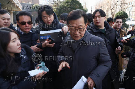 Seok Dong-hyeon, a lawyer for South Korea's impeached President Yoon Suk Yeol, is surrounded by media upon his arrival at a court, in Seoul