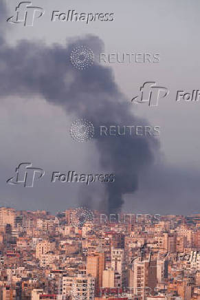 Smoke billows over Beirut's southern suburbs, as seen from Sin El Fil