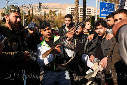 People gather in Umayyad Square after Syria's Bashar al-Assad was ousted in central Damascus