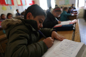 Students in a classroom after authorities announced the reopening of schools, in Damascus