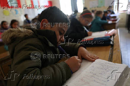 Students in a classroom after authorities announced the reopening of schools, in Damascus