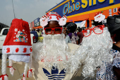 A street vendor sells Christmas hats and Santa Claus beards ahead of Christmas celebration in the district of Adjame in Abidjan