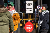 FILE PHOTO: FILE PHOTO: Workers picket in front of a Starbucks in the Brooklyn borough in New York