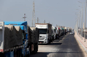 Trucks carrying aid line up near the Rafah border crossing between Egypt and the Gaza Strip, in Rafah