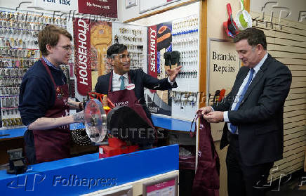 British Prime Minister Rishi Sunak visits a branch of Timpson, in London