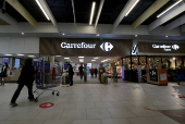 FILE PHOTO: A customer pushes a shopping trolley in a Carrefour Hypermarket store in Nice