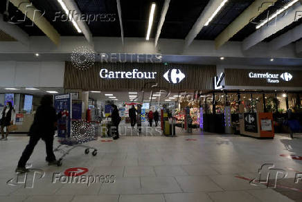 FILE PHOTO: A customer pushes a shopping trolley in a Carrefour Hypermarket store in Nice