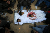 Palestinians mourn loved ones killed in Israeli strikes, in Khan Younis in the southern Gaza Strip