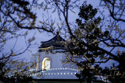 Chiang Kai-shek Memorial Hall stands as plum blossoms in Taipei