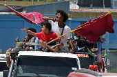Supporters of former deputy speaker Namson Tran cheer and wave ahead of the election in the capital Honiara