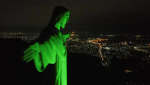 The statue of Christ the Redeemer is lit up in green to celebrate the Indigenous People Day in Rio de Janeiro