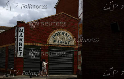 People walk past Foxhall Market in Blackpool