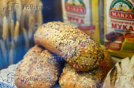 Loaves of bread are seen next to packs of Makfa flour in a showcase of a supermarket in Moscow