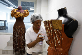 Viviane Kouame, an Ivorian chocolatier, prepares dresses covered of chocolate and chocolate patterns for a fashion show during the ninth edition of the National Cocoa and Chocolate Days in Abidjan