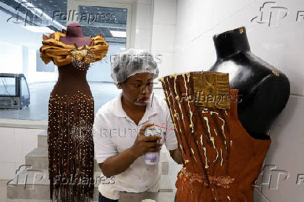 Viviane Kouame, an Ivorian chocolatier, prepares dresses covered of chocolate and chocolate patterns for a fashion show during the ninth edition of the National Cocoa and Chocolate Days in Abidjan