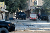 Palestinian security forces patrol amid clashes with militants at the camp in Jenin