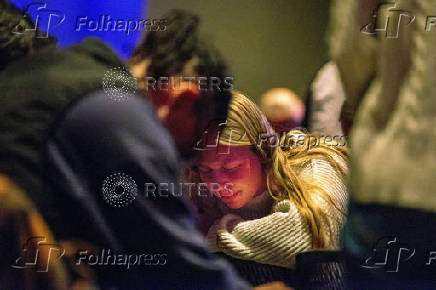 Worshipers at Blackhawk Church gather to pray for victims and survivors of a shooting in Madison