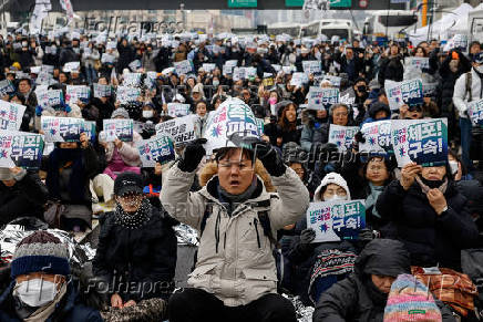 People take part in a protest against the impeached South Korean President Yoon Suk Yeol near his official residence in Seoul