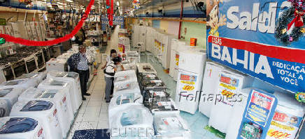 FILE PHOTO: Consumers browse for a washing machine at a Casas Bahia store in Sao Paulo