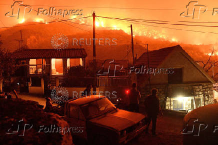 Wildfire burns next to the village of Kallithea, near Corinth