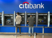 FILE PHOTO: Customers use ATMs at Citibank branch in New York City