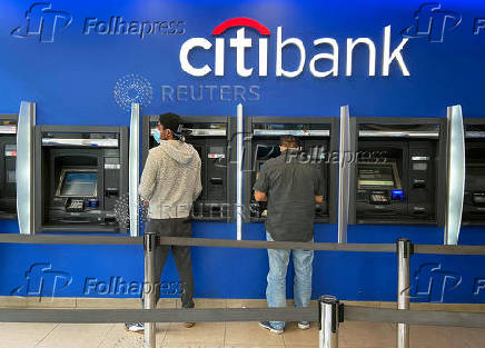 FILE PHOTO: Customers use ATMs at Citibank branch in New York City