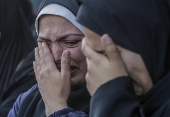 Palestinians mourn their dead at Deir Al Balah hospital after Israeli airstrike in central Gaza