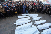 Palestinians mourn loved ones killed in Israeli strikes, in Deir Al-Balah in the central Gaza Strip