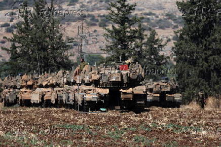 Israeli army soldiers and tanks gather in northern Israel