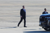 Tesla CEO and X owner Elon Musk walks on the tarmac at Joint Base Andrews