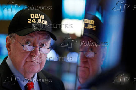 FILE PHOTO: Art Cashin, Director of Floor Operations at UBS, wears a DOW 24,000 hat as he works on the floor of the NYSE as the Dow Jones Industrial Average crosses 24,000, in New York