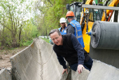 Britain's Foreign Secretary David Cameron visits an irrigation canal site, on the outskirts of Bishkek