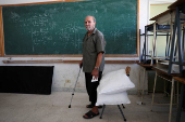 Atef Ahmad Darwich, an 84-year-old man, stands in a classroom at the Technical Institute of Bir Hassan which has been turned into a shelter, in Beirut