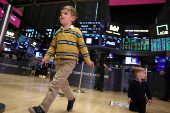 Traders and kids work on the floor of the NYSE in New York