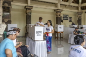 Voters cast their ballots in regional government elections in Indonesia