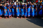 Participants wearing colourful attire, stand in the queue to enter inside the Jawaharlal Nehru International Stadium to perform Bharatanatyam dance, in Kochi