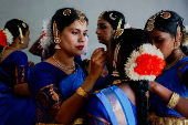 Participants prepare to perform Bharatanatyam dance, at the Jawaharlal Nehru International Stadium, in Kochi