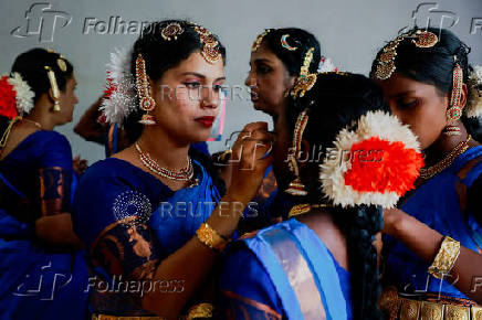 Participants prepare to perform Bharatanatyam dance, at the Jawaharlal Nehru International Stadium, in Kochi