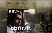 The logo of BBVA bank is seen on a window of a BBVA bank branch office, in Ronda