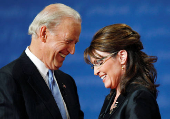 FILE PHOTO: Vice presidential nominees Biden and Palin smile as they chat onstage at the end of their vice presidential debate in St. Louis, Missouri