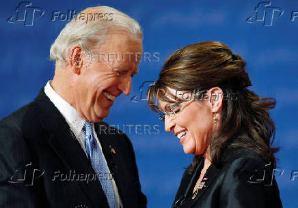 FILE PHOTO: Vice presidential nominees Biden and Palin smile as they chat onstage at the end of their vice presidential debate in St. Louis, Missouri