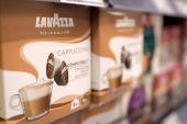 Lavazza products are displayed on a shelf in a supermarket