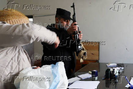 Former members of Syria's Bashar Al Assad's security forces wait to register for the identification and reconciliation process, in Damascus