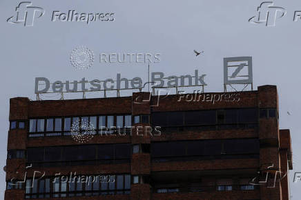 The logo of Deutsche Bank is seen on the roof of a building outside a Deutsche Bank branch office in Malaga