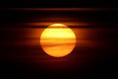 Sunspots are seen on the sun at sunset, as a geomagnetic storm continues hitting the Earth, in Ronda