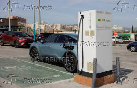 An electric vehicle is plugged into an Iberdrola charging station in Malaga