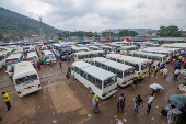 Public transport buses wait for passengers at the terminus stop in the outskirts Kigali,