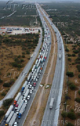 Trucks wait in line to cross into the United States, at the World Trade Bridge