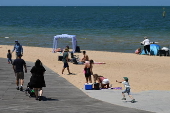 People relax on Melbourne St Kilda beach