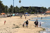 People relax on Melbourne St Kilda beach